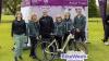 Staff group pose with bike in front of gazebo