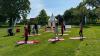people doing yoga on the grass