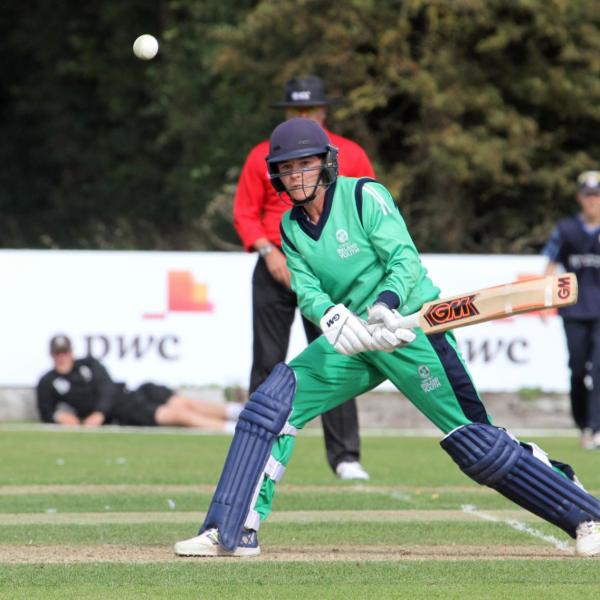 Neil Rock reverse sweeps a four for Ireland in cricket