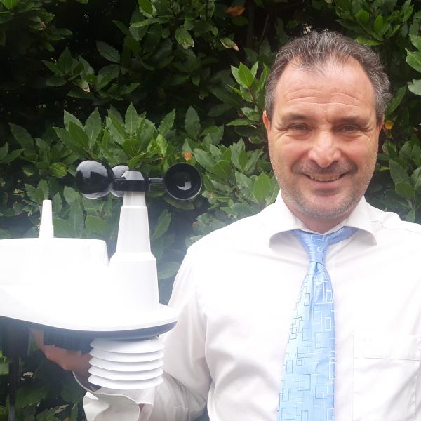 Kevin Vallely holding weather station