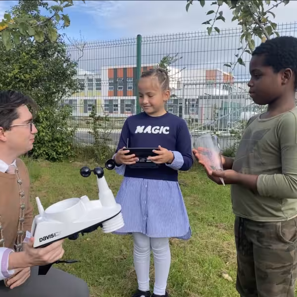 Deputy Mayor Cllr Daniel Whooley showing two 3rd class students in Rush and Lusk educate together the new automatic weather station