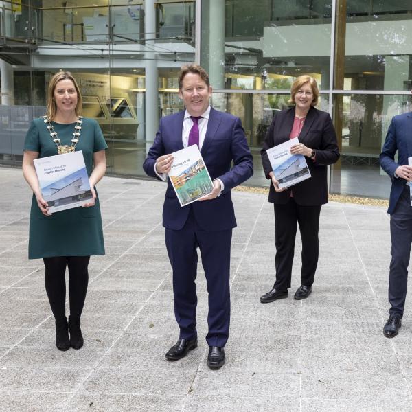 Minister for Housing, Local Government and Heritage, Darragh O'Brien TD presents a copy of the Design Manual for Quality Housing, and a Review of Pre-Construction Processes for Social Housing Construction and Mixed Tenure Projects to Mayor of Fingal Cllr Seána Ó Rodaigh, Fingal County Architect Fionnuala May, Cllr Robert. O'Donoghue, Chair of the Housing Strategic Policy Committee and Fingal County Council Chief Executive AnnMarie Farrelly. 