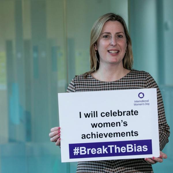 Mayor holding sign for international womens day 2022 at county hall. Sign reads celebrating womens acheivements.