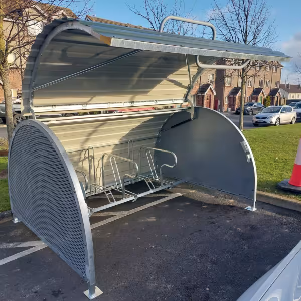 Open bike storage bunker with green metal door