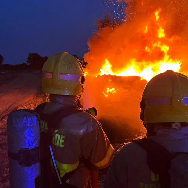 Fire personnel observe raging fire