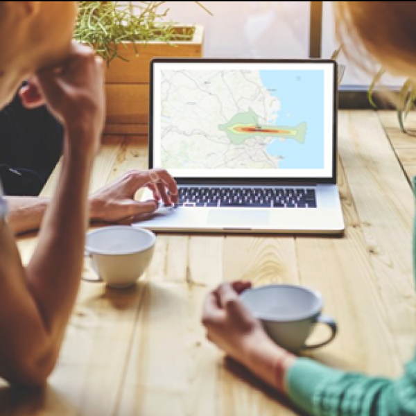 People looking at map on laptop screen