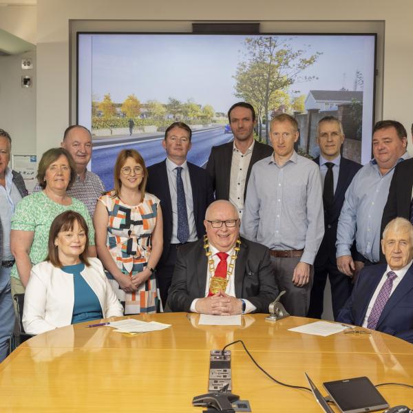 Group of people gathered at conference table