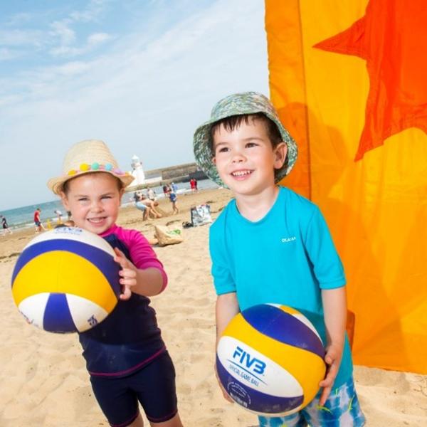 Two Young Children With Volleyballs at the Balbriggan Beach Festival-