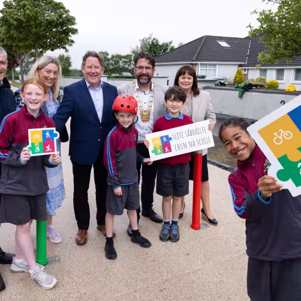Minister, Mayor, CE and Pupils celebrating the completion of the Safe Routes to School works carried out at Pope John Paul II NS, Malahide.