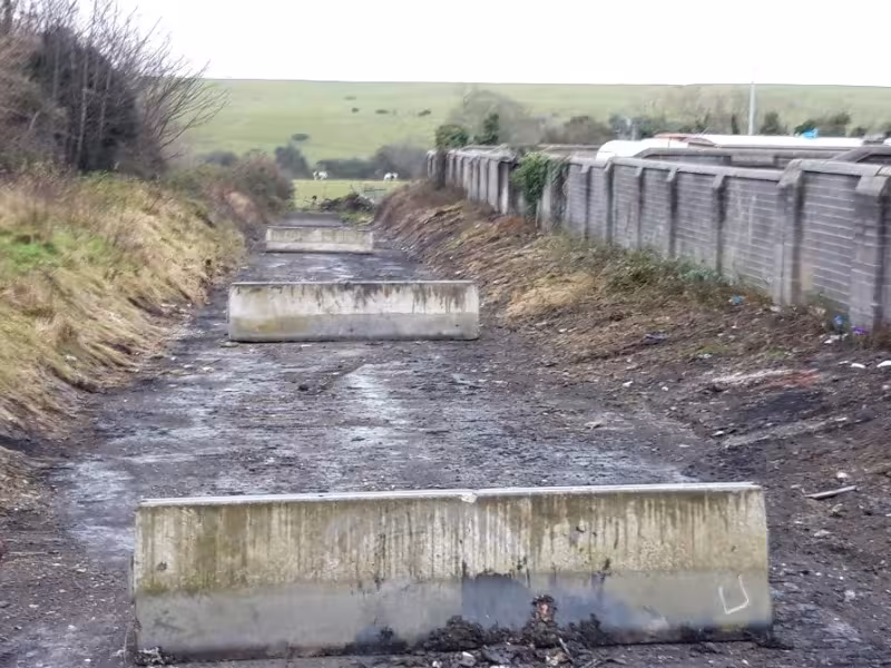 The concrete blocks that were erected to restrict access to the road to prevent illegal dumping