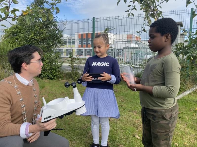 Deputy Mayor Cllr Daniel Whooley showing two 3rd class students in Rush and Lusk educate together the new automatic weather station