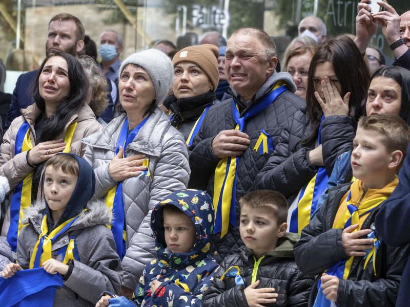 Members of the Ukrainian community sing their national anthem during the raising of the Ukraine flag at County Hall, Swords, today. 