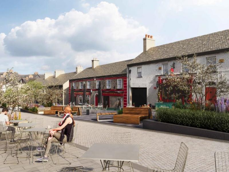 pedestrian street with cafe tables and planting