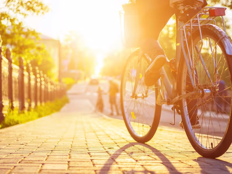 Bike wheel highlighted by sunset
