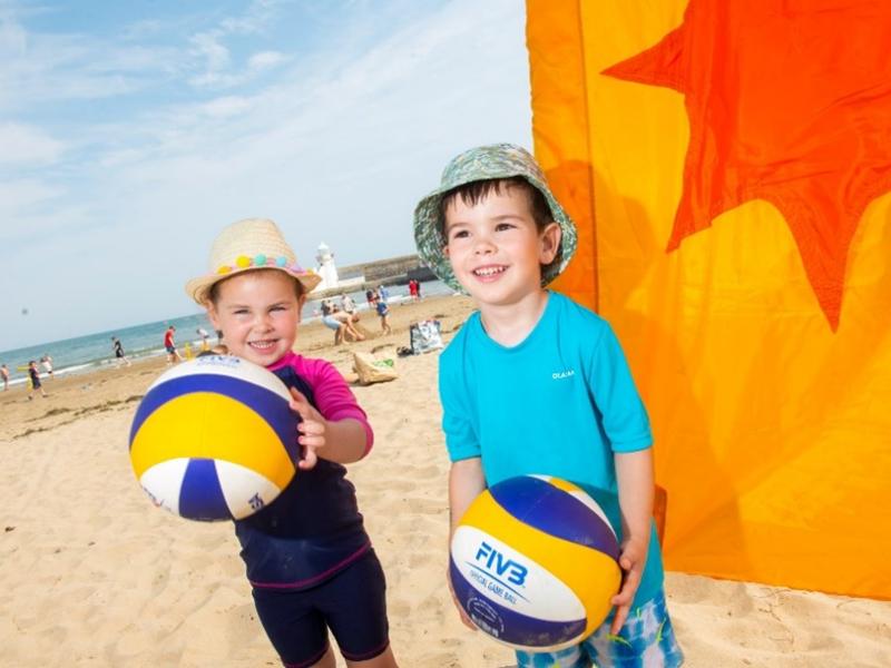 Two Young Children With Volleyballs at the Balbriggan Beach Festival-