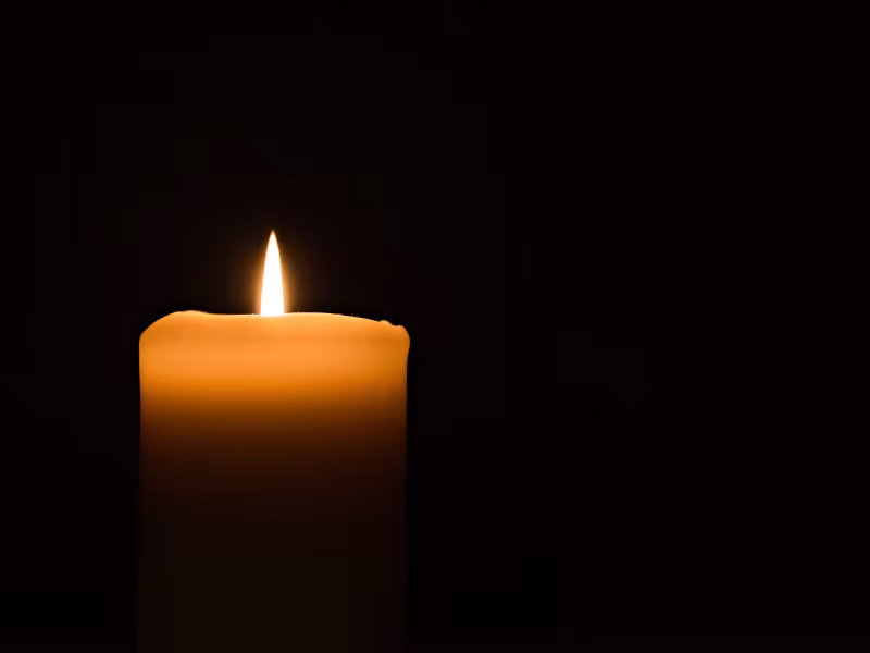 Candle on dark background