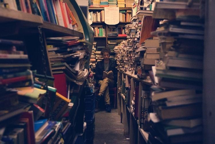 image of a man reading a library book