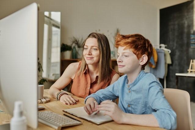 Image of 2 people looking at computer