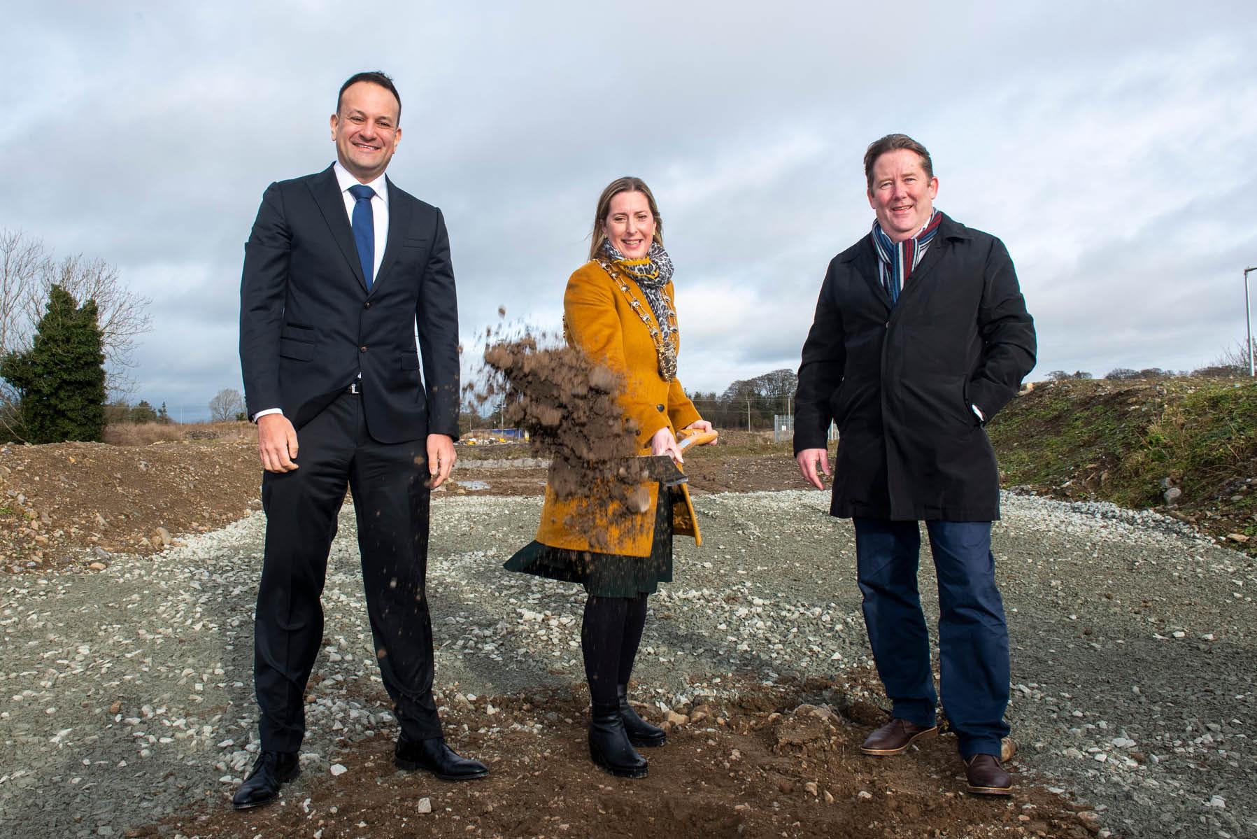Mayor, Tainaiste and Minister for Housing on site turning first sod with spade