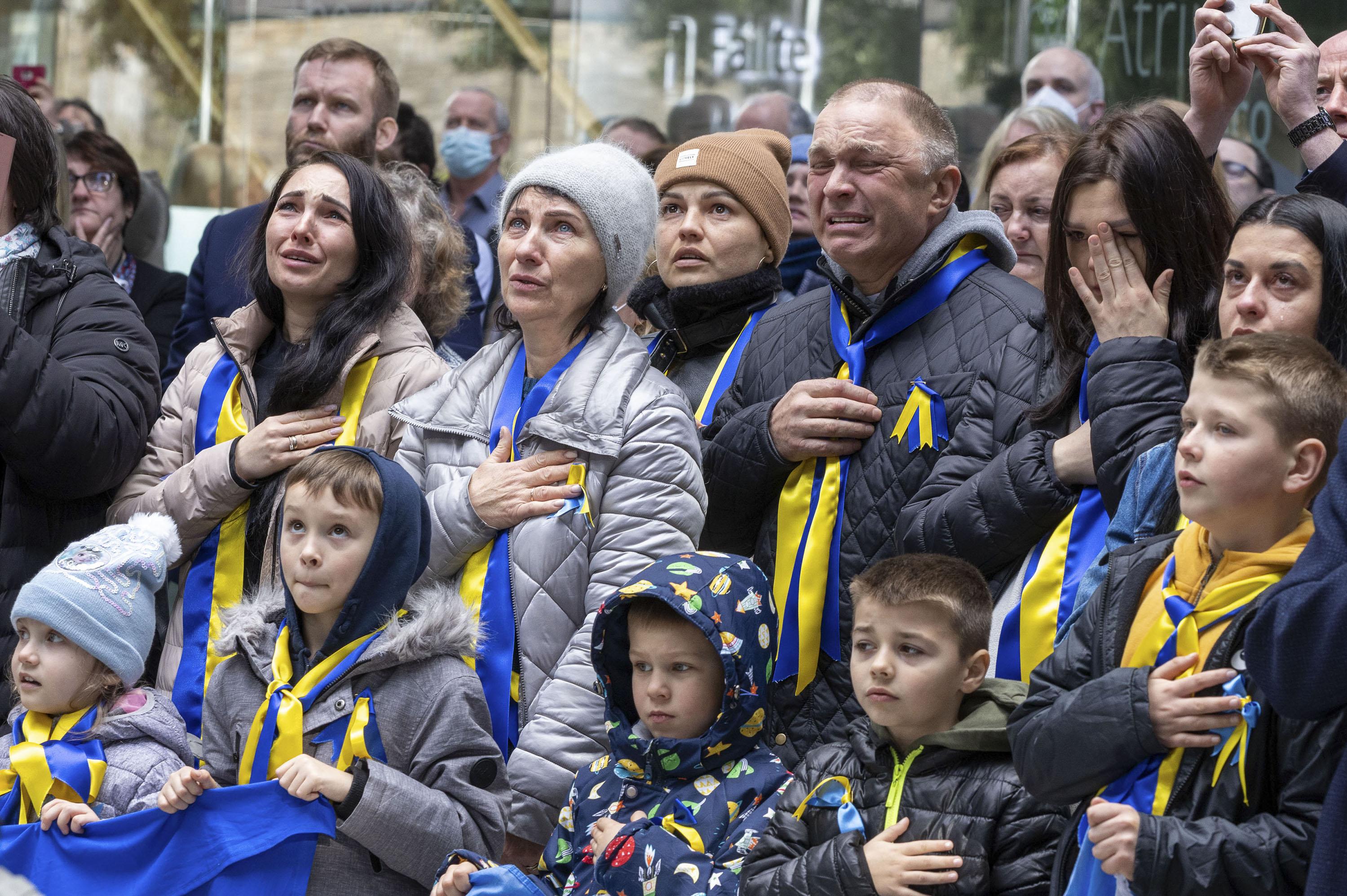 Members of the Ukrainian community sing their national anthem during the raising of the Ukraine flag at County Hall, Swords, today.