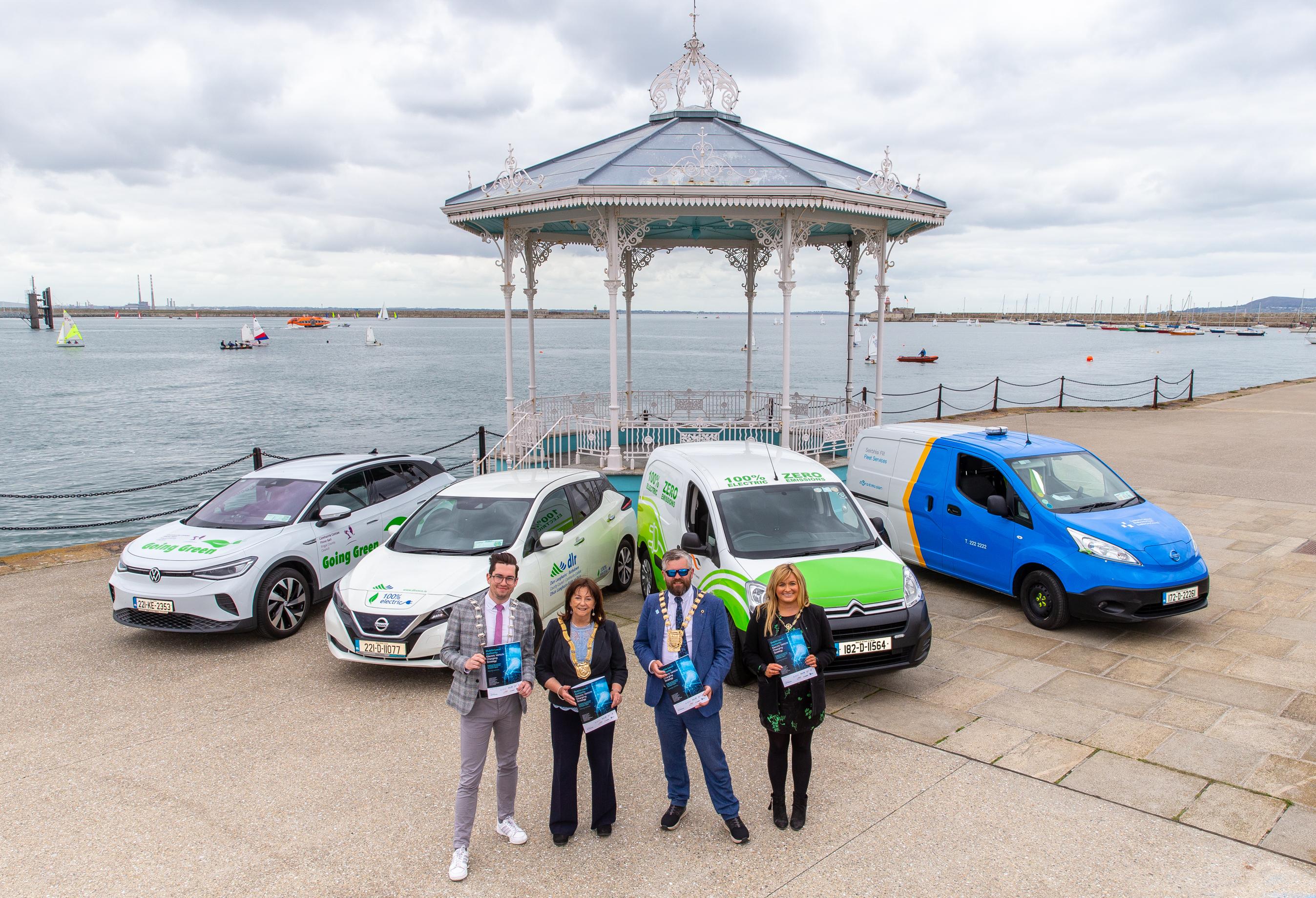 4 Mayors stand at cars holding document