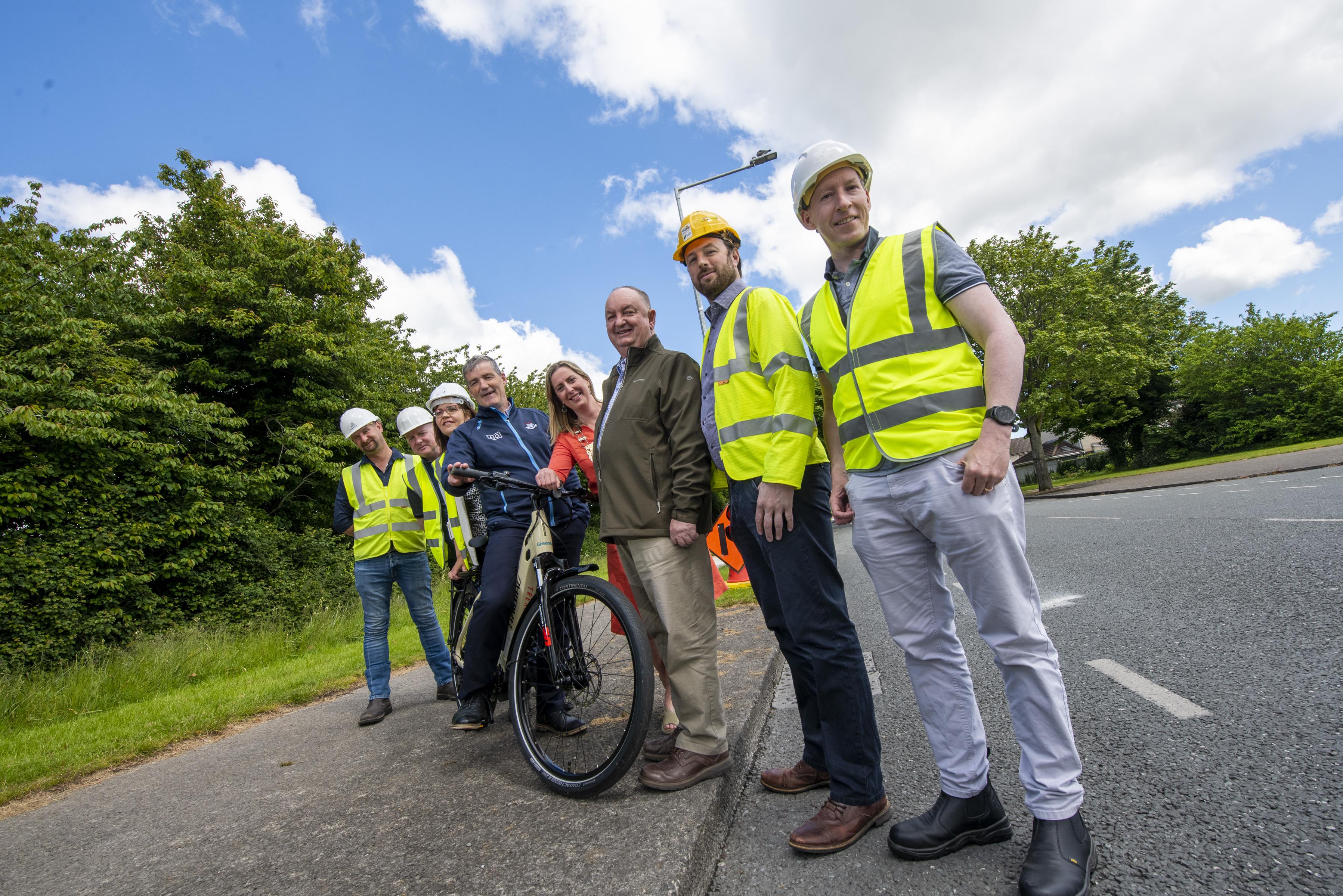 Team in hi vis vests and hard hats with bike