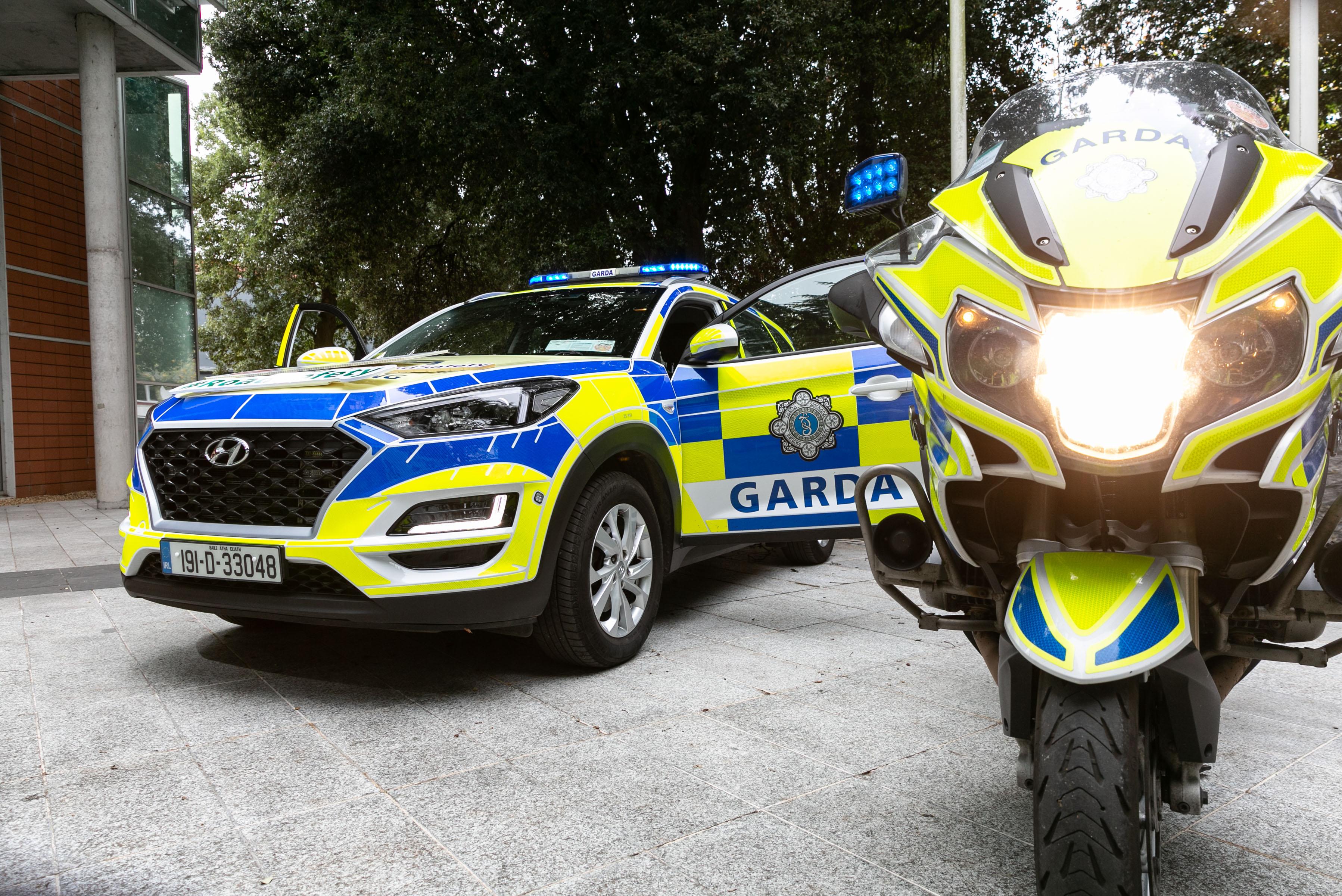 Garda bike and car with lights on