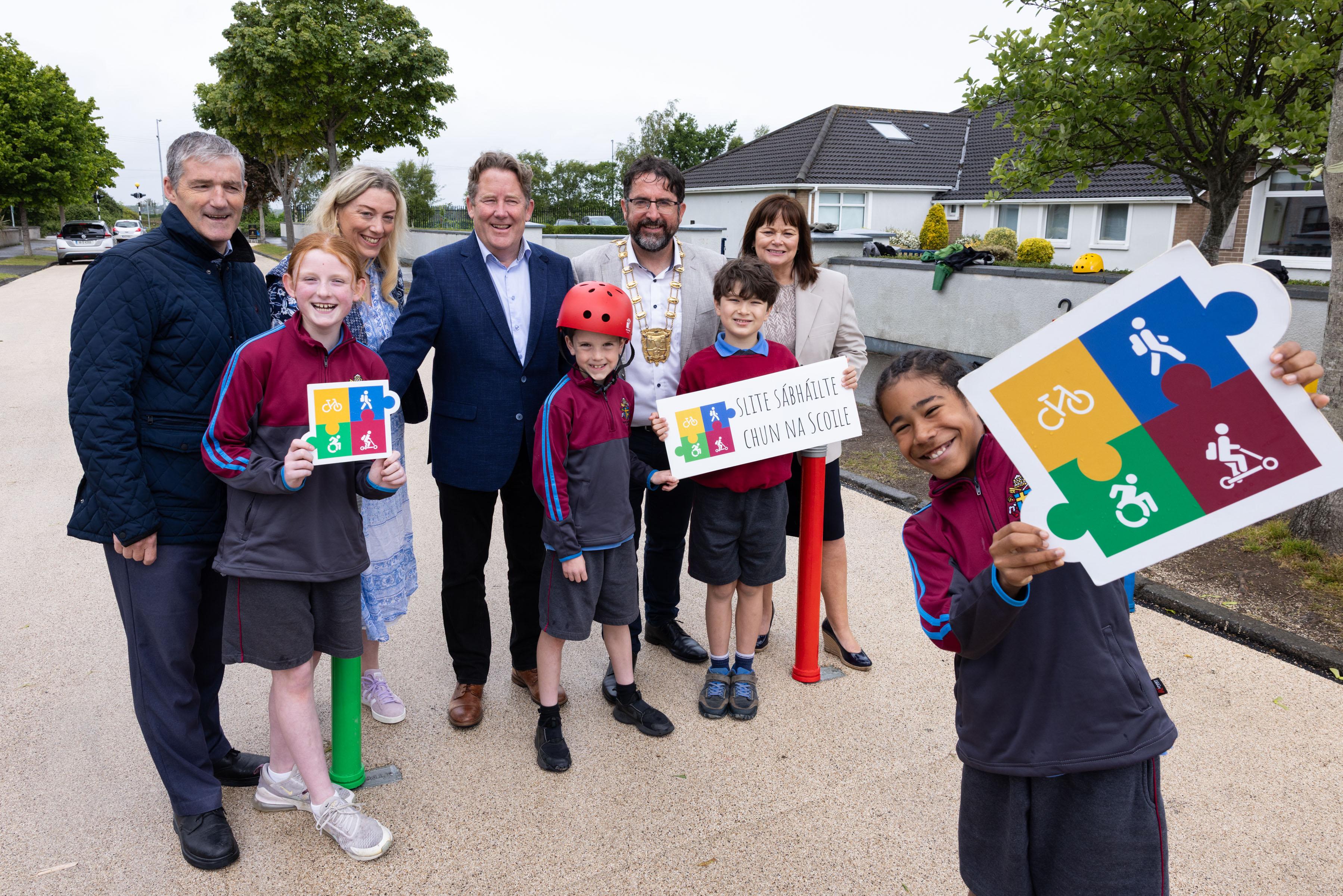 Minister, Mayor, CE and Pupils celebrating the completion of the Safe Routes to School works carried out at Pope John Paul II NS, Malahide.