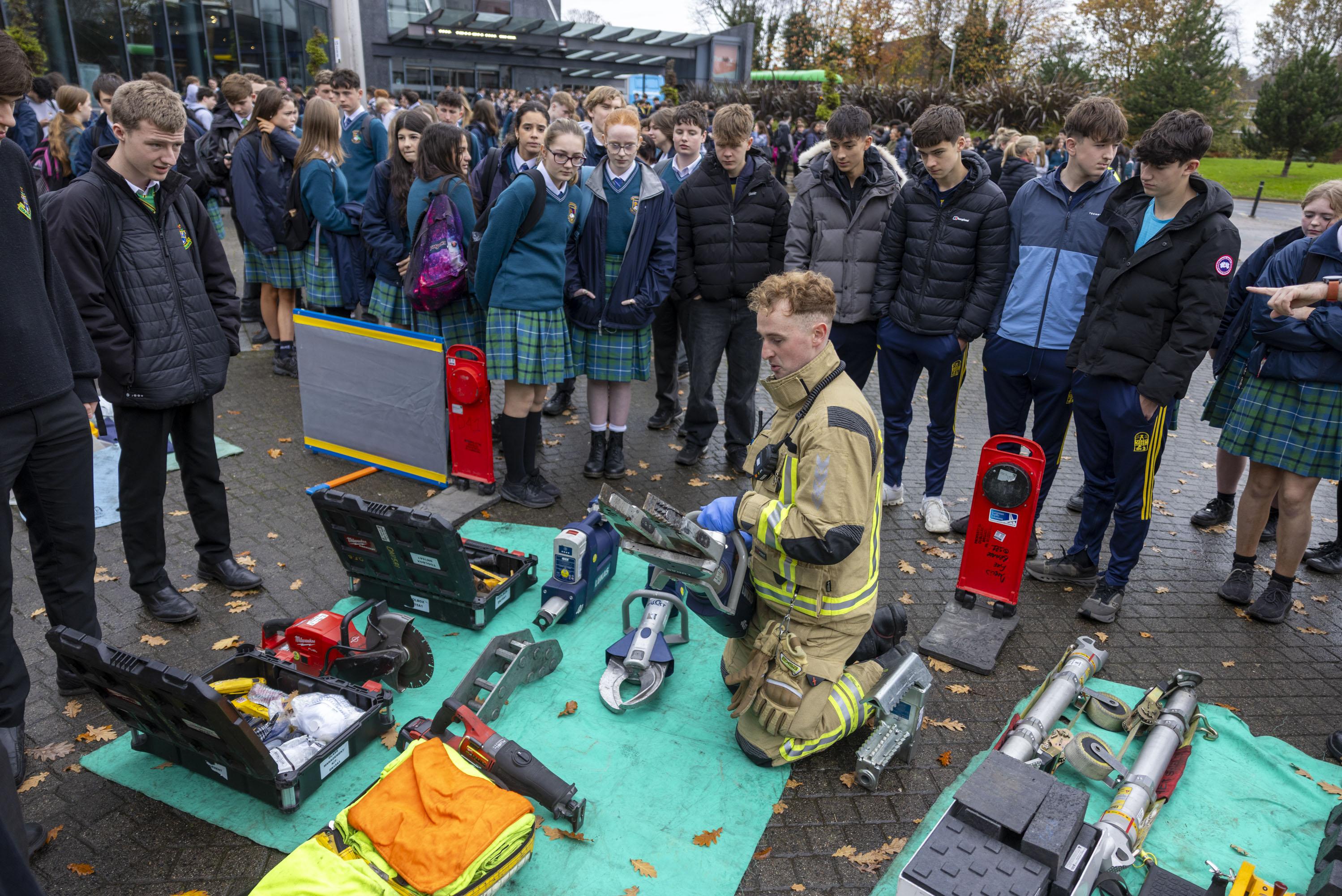 Students look on at a member of the Emergency Services giving a crash reenactment demonstration at axa roadsafe roadshow 