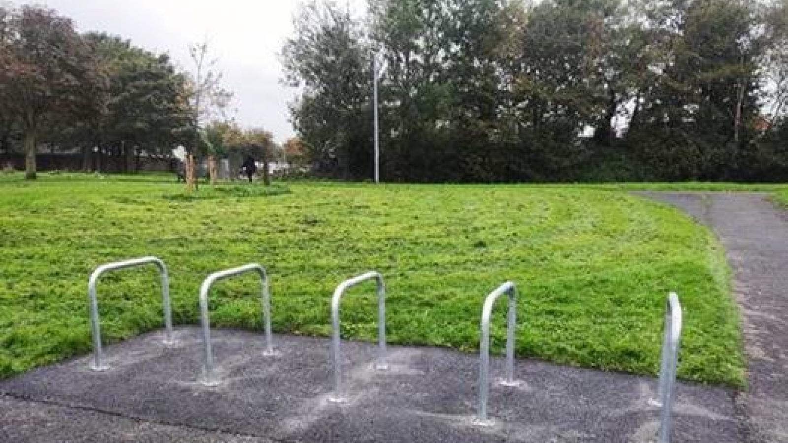 empty bicycle stands next to grass at seagrange basketball court baldoyle